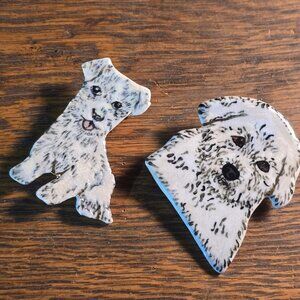 Two ceramic white dog brooches. Bichon Frise? West Highland White? Malti-poo?
